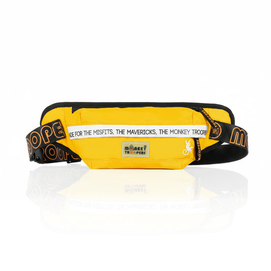 Yellow Slay Fanny Pack by Monkey Troopers, showcasing a stylish travel accessory with subtle reflection and shadow detail.